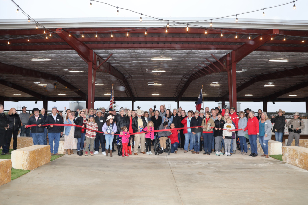 ROCK volunteers and donors cut a ribbon at the Sports Clips Area on November 10. The facility was funded by the Miracles in the Dirt Campaign. Photo by Ron Parks.