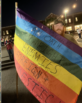 Benjamin Clodfelter, with Veterans for Equality, holds a flag that he said represents the protection of marginalized groups.  (Photo by Abbey Archer)