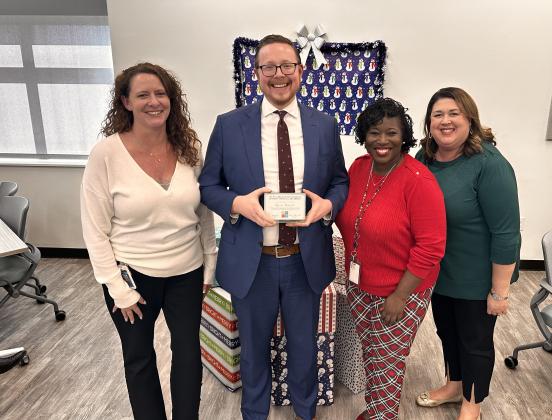 Ryan Bownds, center, stands with Chief Executive Officer Kerrie Stannell, left, Director of Client Services Felicia Coleman, and Chief Program Officer Jennifer Deazvedo, right, of the Williamson County Children’s Advocacy Center. Photo courtesy of the Williamson County District Attorney’s Office.