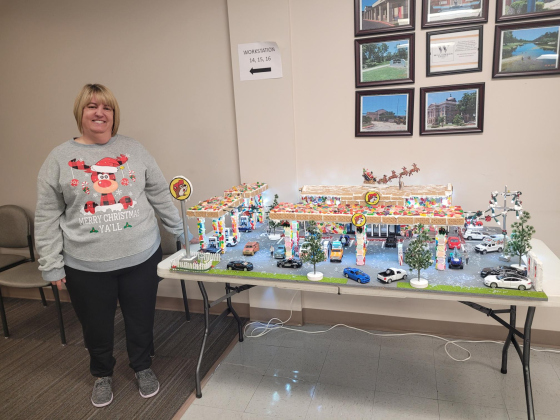 Williamson County Accountant Deanna Vaters stands with her Buc-ee's Gingerbread house in the County Tax Assessor’s office. She began preparing for the project in September. The display took her three days to build.