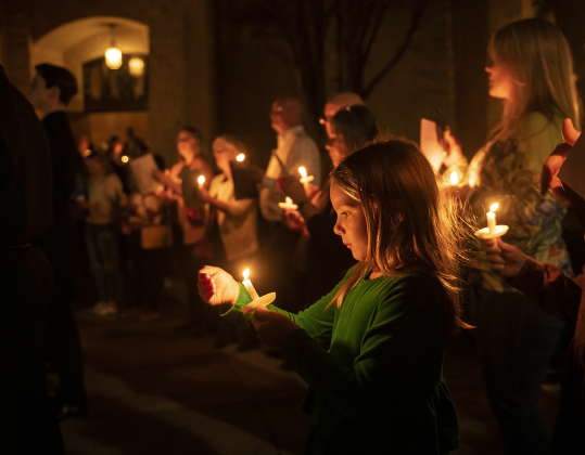 7-year-old Zinnia Crenshaw joins her family outside Lois Perkins Chapel to sing "Silent Night"  at the conclusion of Southwestern University's Candlelight Service at Lois Perkins Chapel on Thursday, December 7, 2023.
