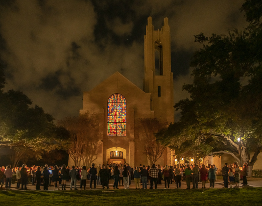 Attendees gather outside Lois Perkins Chapel to join in the singing of "Silent Night" at the conclusion of  Southwestern University's Candlelight Service on Thursday, December 7, 2023.