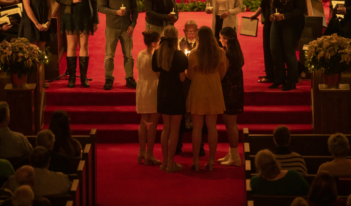 Rev. Dr. Ronald Swain, Southwestern's Chaplain, begins to light candles of ushers, who then added candlelight to attendees during Southwestern University's Candlelight Service at Lois Perkins Chapel on Thursday, December 7, 2023.
