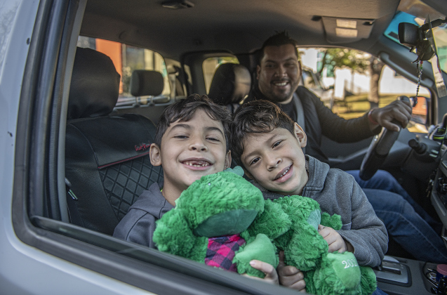 Emerson Alba, 8, left, and his brother Isaac, 5, with their father Kelby Alba, were among the recipients during the Georgetown Police Department's Blue Santa distribution, held Saturday, December 16, 2023.