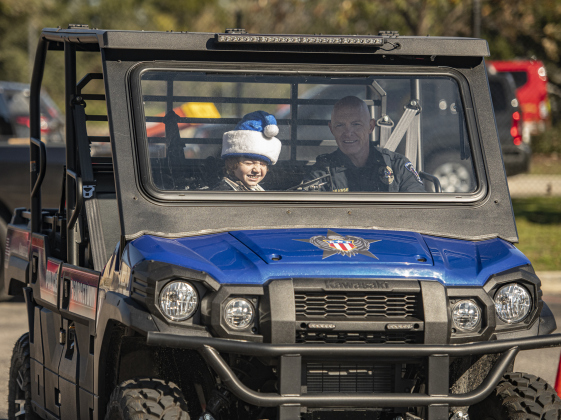 9-year-old T.C. Grasse rides with his dad, Georgetown Police Department Commander Erik Grasse during the Georgetown Police Department's Blue Santa distribution, held Saturday, December 16, 2023.