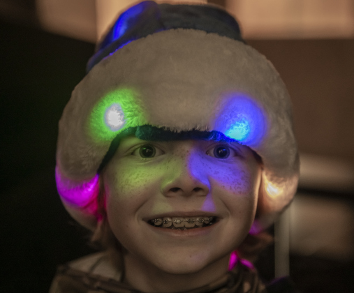 9-year-old T.C. Grasse, the son of Georgetown Police Department Commanders Erik Grasse and Renee Koog, had colorful lights adorning his blue Santa cap  during the Georgetown Police Department's Blue Santa distribution, held Saturday, December 16, 2023.
