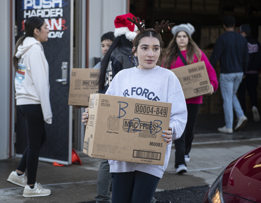 Caitlin Gomez, 14, was one of the volunteers helping hand out gift boxes during the Georgetown Police Department's Blue Santa distribution, held Saturday, December 16, 2023.