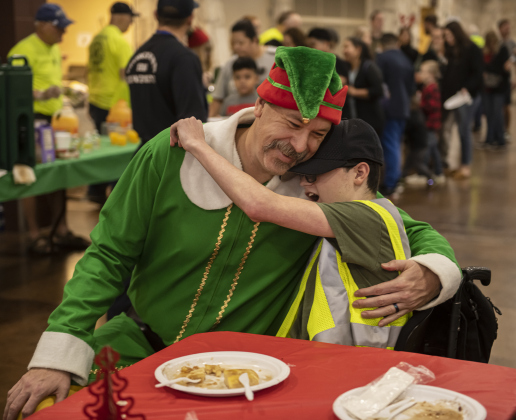 Georgetown firefighter Rebel Paulk, dressed as Buddy the Elf, gave a big hug to attendee Logan Parker, 16, at the San Gabriel Community Center for Breakfast With Santa on Saturday, December 23. Attendees were treated to pancakes, breakfast sausage and orange juice. Children had their photos taken with Santa and each family received a free copy. Proceeds from the event help families and children during the holiday season.