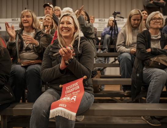Terilyn Henderson, mom of Hutto 4-H Club member Brady Henderson, 11, claps after Brady won a Reserve Champion award in the Market Goat division  at the Williamson County Livestock Show  on Monday, December 4, 2023.