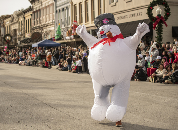 A large snowman makes its way along Austin Avenue during the parade.