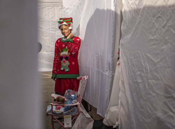 Bonnie Stewart, 11, dressed in holiday attire, helped oversee the 4-H Club booth along Main Street.