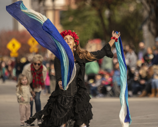 Joy Dilloway stays active along Austin Avenue as she and the crowd wait for the parade to begin.