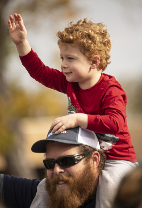 Jeff Melend and his son Levi, 3, enjoy watching the parade along Austin Avenue.