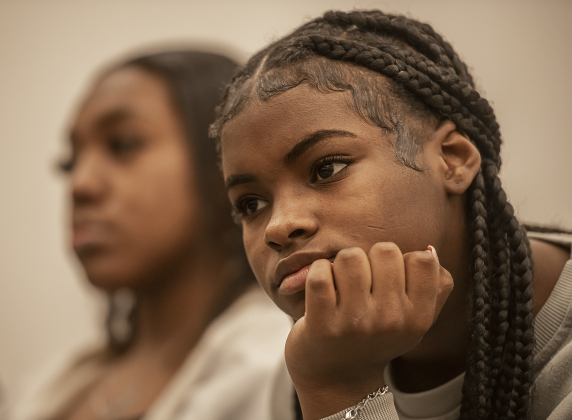 Chloe Miles, 13, front, and her sister T'Niyah Miles, 17, back left, were among those taking part in Taylor's Dr. Martin Luther King, Jr. holiday observance held in the Taylor City Hall auditorium.