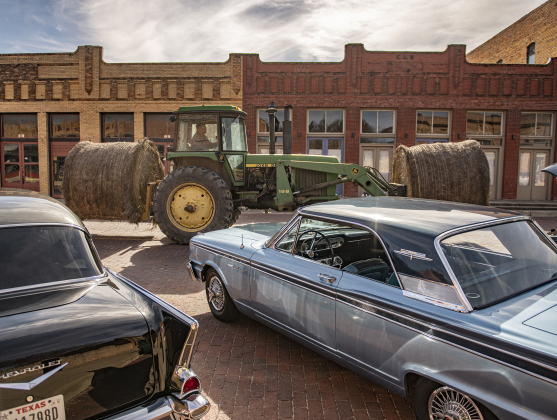  A tractor toting hay bales makes its way along East Clark Street.