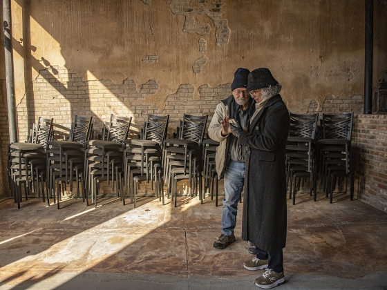 Photography Club members Randall Best and Silvia Barcellos compare photos taken in an historic Bartlett building.
