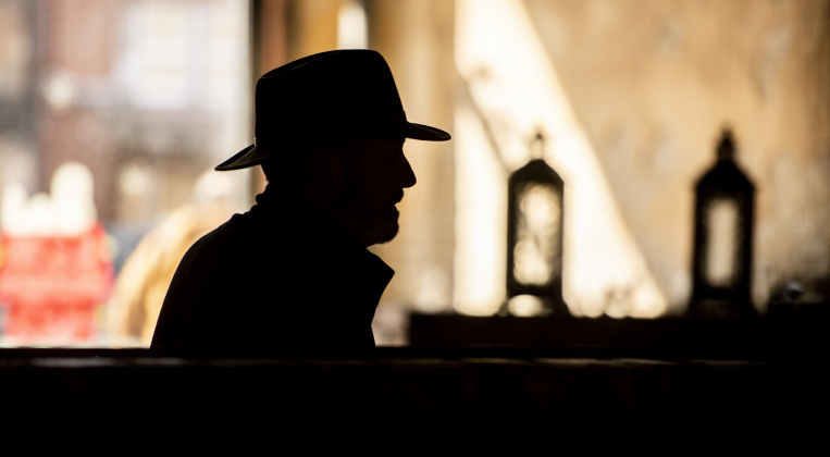 Georgetown-based photographer Tom Cavness is silhouetted as he listens to a photographer's presentation at The Urban at Bartlett.