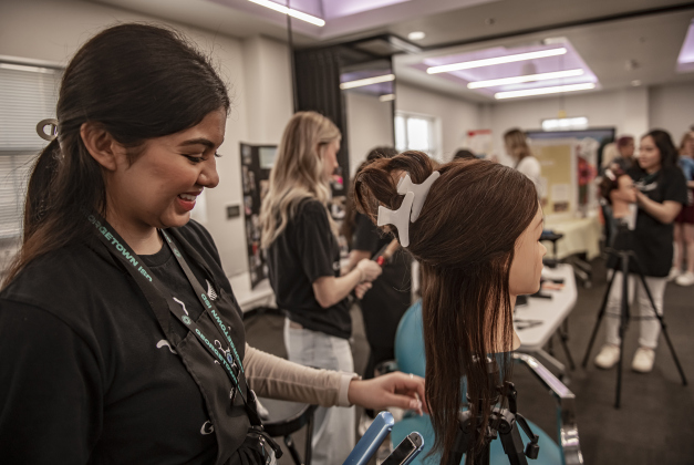 East View High senior Ashley Guerrero, 17, joins others in demonstrating their Cosmetology class skills during the Georgetown Independent School District State of the District event held at GISD headquarters on Thursday, February 15, 2024.    Photo by Andy Sharp.