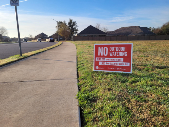 A yard sign tells residents of Cold Springs in Leander to practice Phase 4 water restrictions in preparation of the BCRUA pipeline shutoff. Photo by Nalani Nuylan.