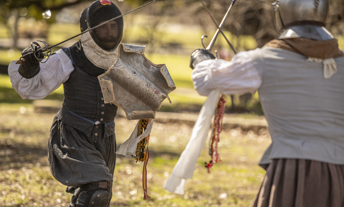 John Drake, left,  competes in a fencing match with Miles Ridley.