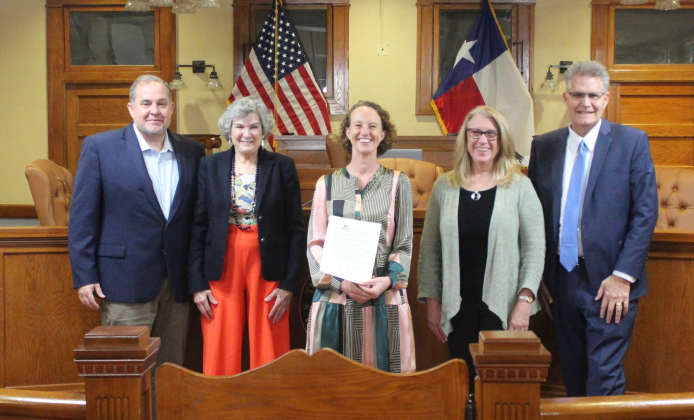 I Live Here I Give Here’s Executive Director Piper Stege Nelson, center, stands with the Williamson County Commissioner's Court after reading the proclamation making March 6-7 Amplify Wilco Days during the February 27 court meeting. Photo courtesy of Williamson County.