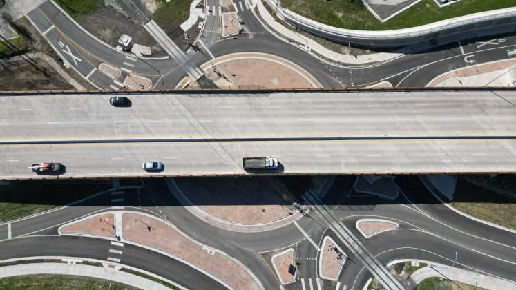 An aerial shot shows the new RM 620 roundabout with the overpass bridges nearby.  Photo Courtesy of Texas Department of Transportation.