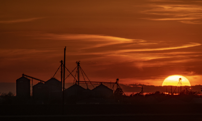 The sun begins to go down over grain elevators in downtown Granger just before 7:30p.m. on Monday, March 11.  Photo by Andy Sharp