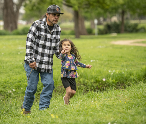 Ben Nava, a Lipan Apache who for years helped coordinate the powwow at Southwestern University, is shown with his 3-year-old granddaughter, Adelynn Bunch.