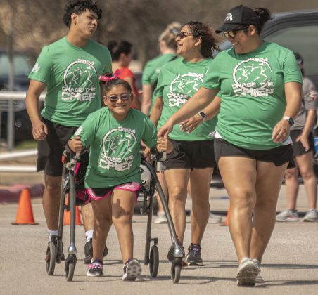 Ari Mata, 10, a student at Wolf Ranch Elementary School,  is seen with her mom Nani Mata, right, as they near the finish line  in the Fun Run.