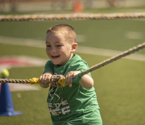 6-year-old Payton Phelps, with a group from the YMCA of Georgetown, participates in a tug o' war in the fitness fair