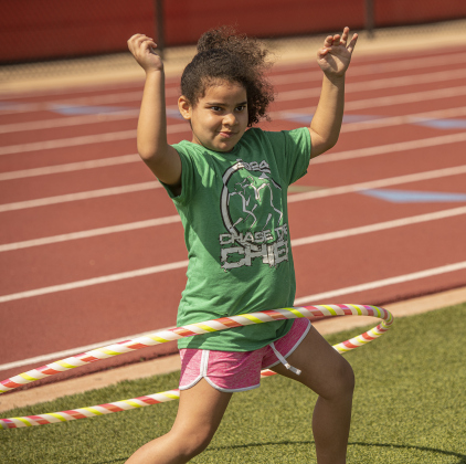 6-year-old Eleanor Cruz enjoys a Chula Hoop, similar to a traditional Hula Hoop, but with added weight built in as she participates in the fitness fair.