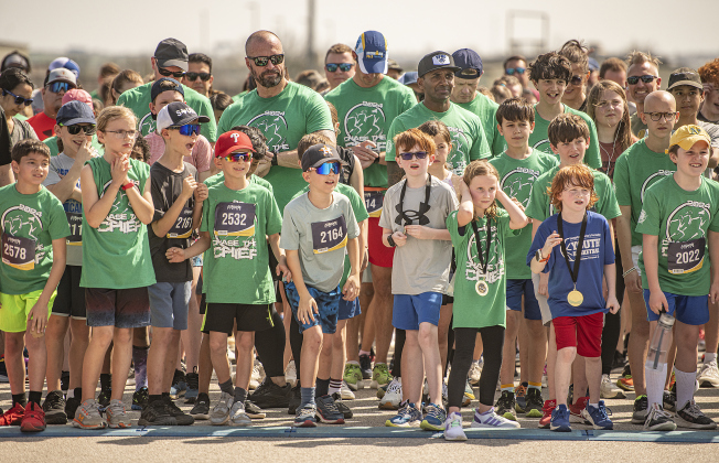 Georgetown Police Chief Cory Tchida (back left, sunglasses, no cap) stands with Georgetown I.S.D. Superintendent Dr. Devin Padavil (in black baseball cap) as they prepare to run in the 5K race.