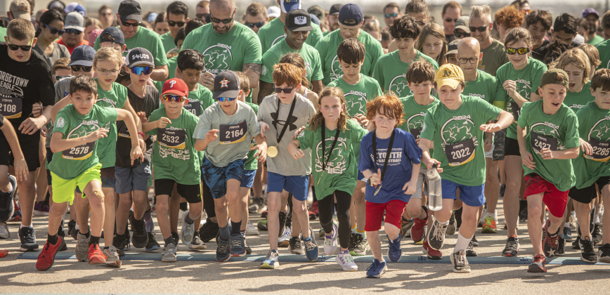 Georgetown Police Chief Cory Tchida (center left, sunglasses, no cap) and Dr. Devin Padavil, Georgetown I.S.D. Superintendent (black baseball cap, next to Tchida) participate in the 5K race.