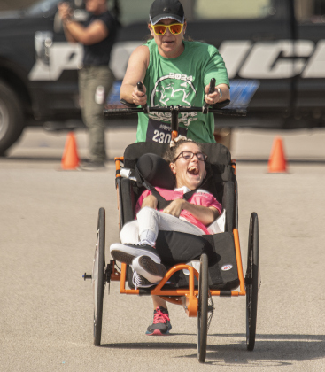 Noelle Swartz and Melody Lusk (pushing Noelle) were members of an Ainsley's Angels team participating in the 5K race.