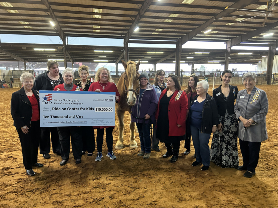 From left are Janis Keene, Carol Joiner, Brenda Kane, Regent Suzanne Jordan, Katherine Howell, Henry and Marcia Koenman from ROCK, Kathleen Davidson, Caroline Miller, Jennifer Williams, Judith Willard, Vanessa Buzgheia and Carole Lowe.  Photo courtesy of Ride On Center for Kids.