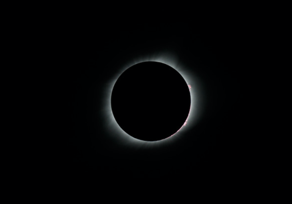 Solar flares peek out from behind the moon during 2017’s total solar eclipse, the most recent in the continental U.S. (Courtesy Jeff Ridings)