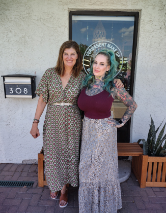 Kelly Ann Carney, owner of Therapie Boutique, and Kandy Mitchell, owner of Silver Moon Curios, stand in front of the Co-Op building at 308 West Eighth Street.