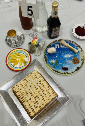 A photo shows a catered Seder Dinner. 
