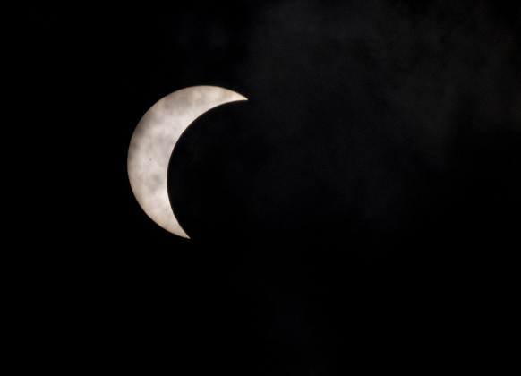  The moon's shadow continues covering the sun's surface at 1:10 p.m. on Monday, April 8.