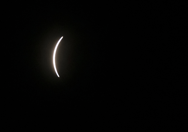 The sun is barely visible after being mostly covered by the moon's shadow just after 1:30 p.m. on Monday, April 8.