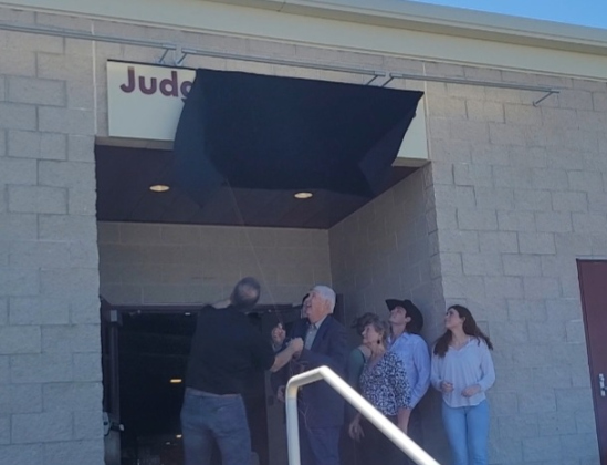 Former County Judge Dan A. Gattis, center, unveils the naming plaque to the Judge Dan A. Gattis Pavilion located at the county Expo Center, April 11. Photo by Nalani Nuylan.