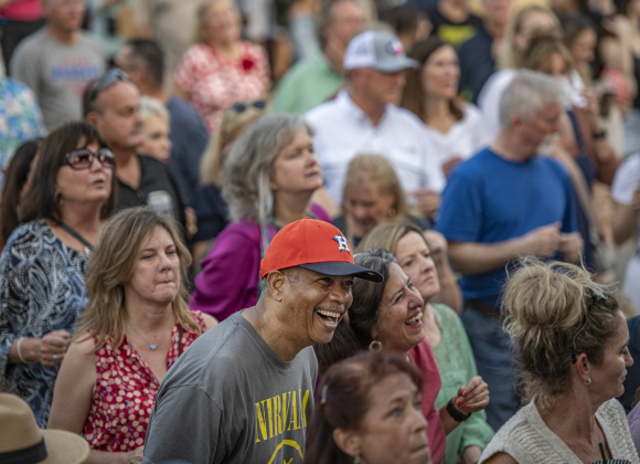 Keith Murray (in Astros cap) enjoys a performance by  Dysfunkshun Junkshun on  the opening night of the Red Poppy Festival on Friday, April 26.  Photo by Andy Sharp