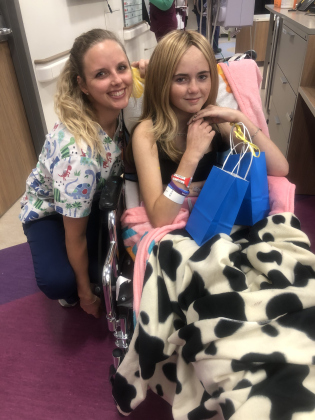 During her cancer treatment, Brooklynn Miller sits with a gift bag before giving it to a nurse at Dell Children’s Medical Center in Austin.