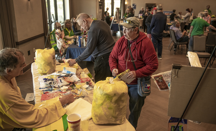 Joe Harlukowicz, left, with Sun City Recycles, visits with Sue Gavron about recycling plastic items during Sun City's Earth Day Celebration event held at The Retreat in Sun City.