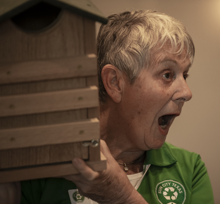 Therese Verdonk (there are accents over the first two e's in her first name) holds up one of the screech owl boxes given away as door prizes  during Sun City's Earth Day Celebration event held at The Retreat in Sun City on Monday, April 22.