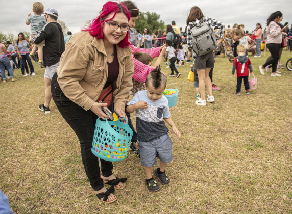 3-year-old Ismael Pulido is assisted by his mom Rebecca Pulido as he collects Easter eggs during the annual Easter egg hunt at Georgetown Church of the Nazarene on Saturday, March 30, 2024.