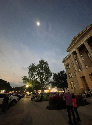 The eclipsed sun can be seen over the Williamson County Courthouse April 8 as observers look up from the lawn.