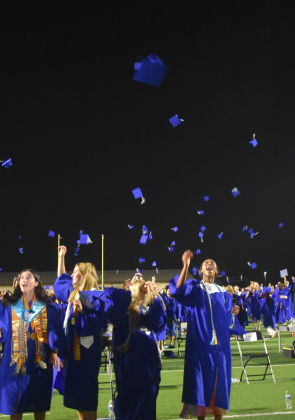 Georgetown High School graduates toss their caps in the air May 24, 2024, during their graduation ceremony. .