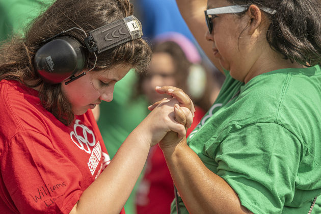 Williams Elementary School 5th grader Kherington Clawson, left, spends time with paraprofessional Rocio Rarmirez before taking part in competition at  the Georgetown Independent School District's annual Special Olympics, held Tuesday, May 7, 2024  at the district sports complex behind Georgetown High School.     Photo by Andy Sharp.