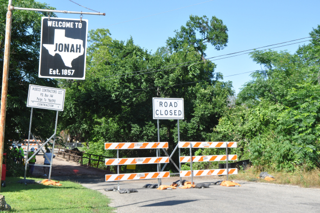Contractors stand on the Jonah Bridge Tuesday, May 14, as machinery underneath prepares the area for demolition. The about 100-year-old bridge was part of Old Highway 29 and took vehicles over a creek. Photo by Nick Cicale.